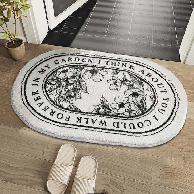 Tapis de bain ovale blanc à thème jardin avec motif floral et texte noir