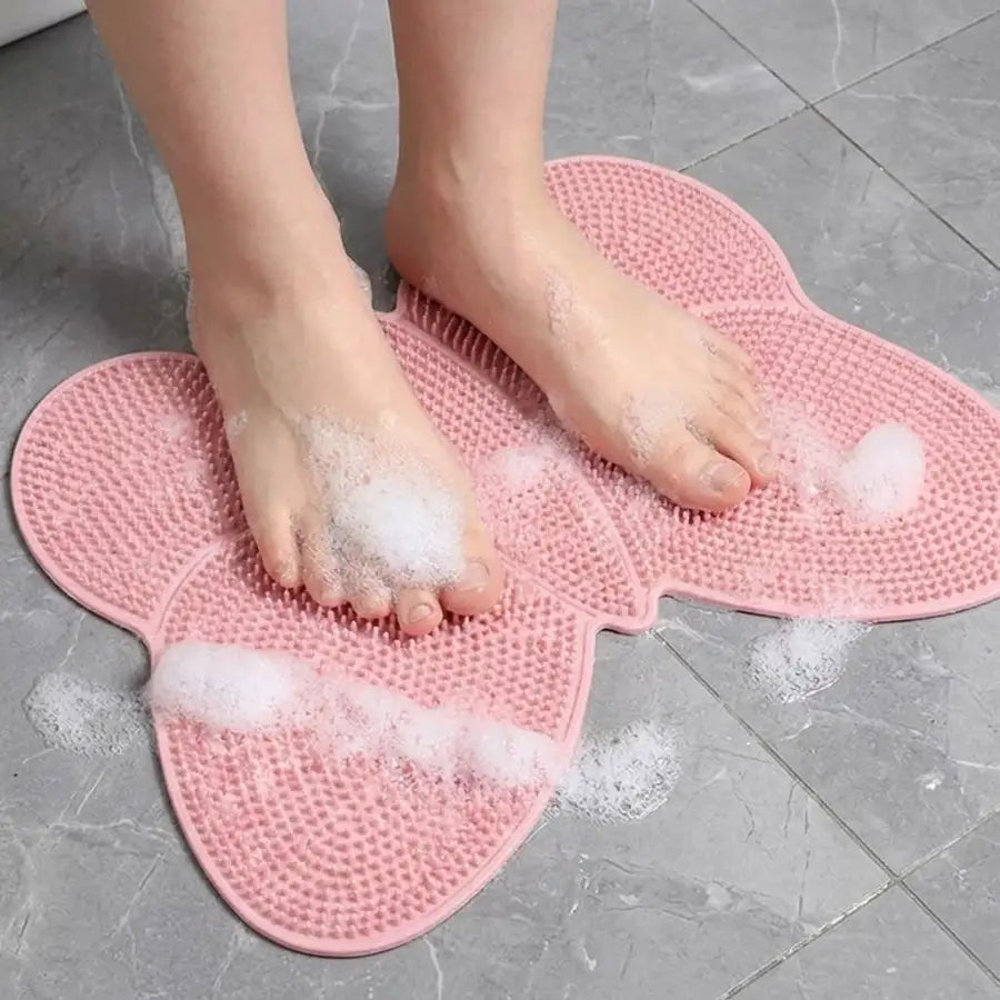 Tapis de gommage des pieds en silicone rose avec surface texturée et bosses surélevées pour l’exfoliation