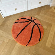 Tapis orange en forme de ballon de basket avec des lignes noires, matériau moelleux.