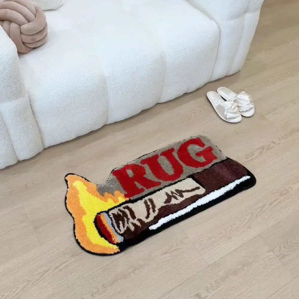 Un tapis moelleux en forme de flamme avec le mot « tapis » en lettres grasses rouges sur sa surface.