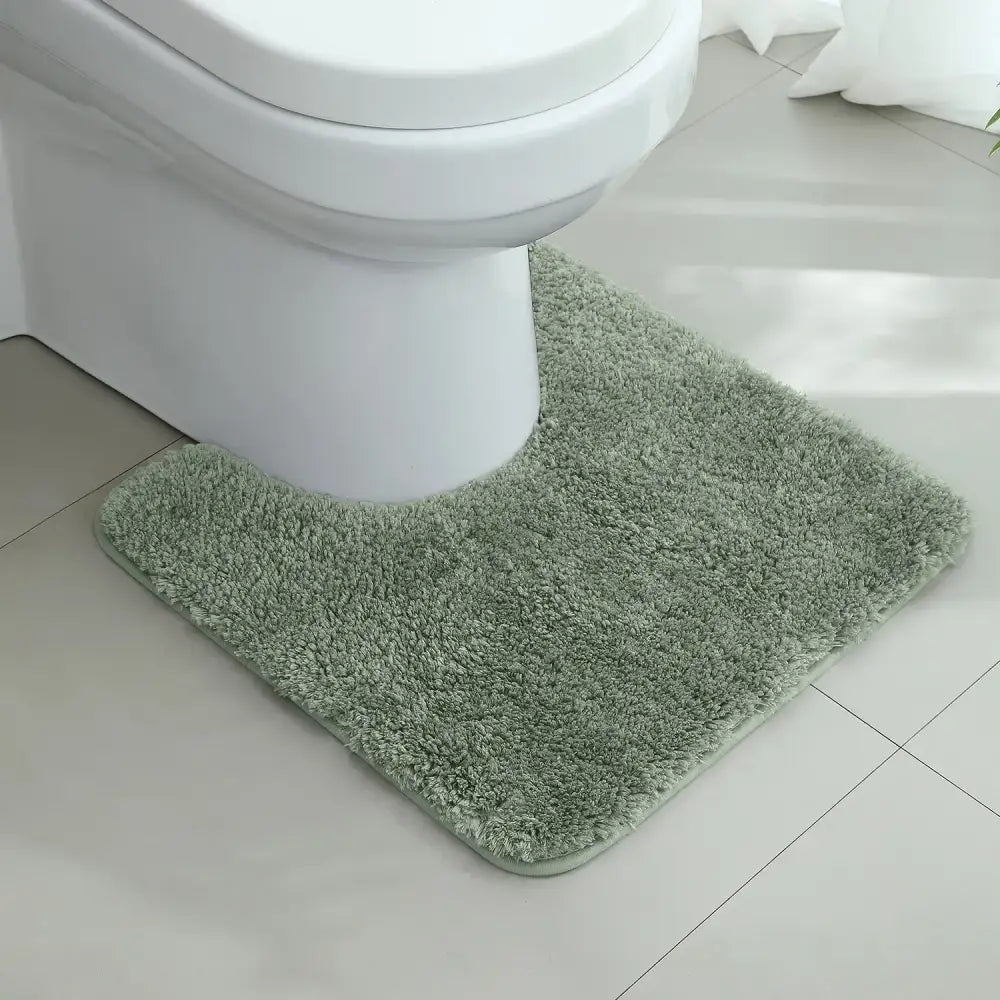 Tapis contour wc vert sauge en tissu doux et moelleux avec bord légèrement surélevé pour sadapter au pied des toilettes
