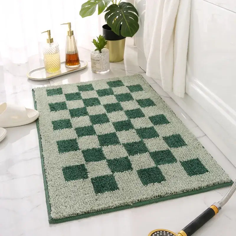 Tapis de bain à carreaux verts et blancs avec une pile texturée, probablement fabriqué en microfibre ou un matériau similaire.