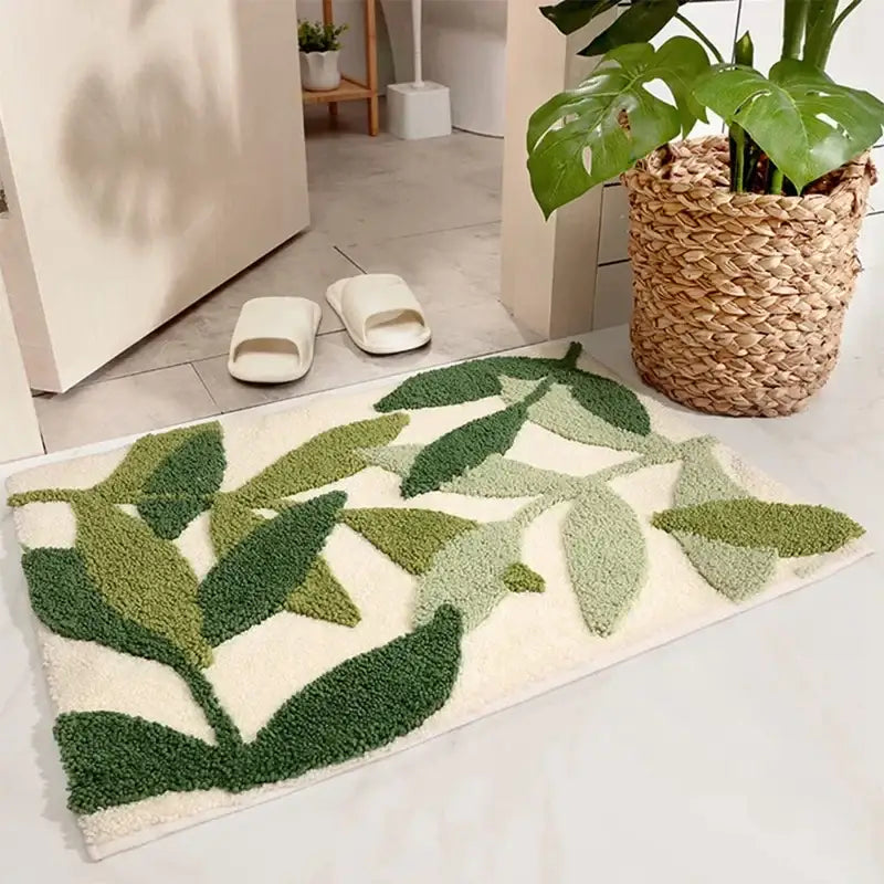 Tapis de bain feuille verte sur fond blanc, design à poils texturés, texture de panier tissé sur le côté.