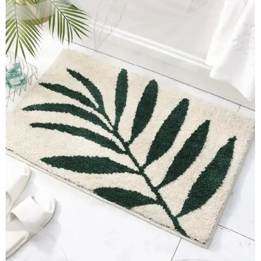 Tapis de bain feuille verte sur fond blanc, matériau doux, design moderne.