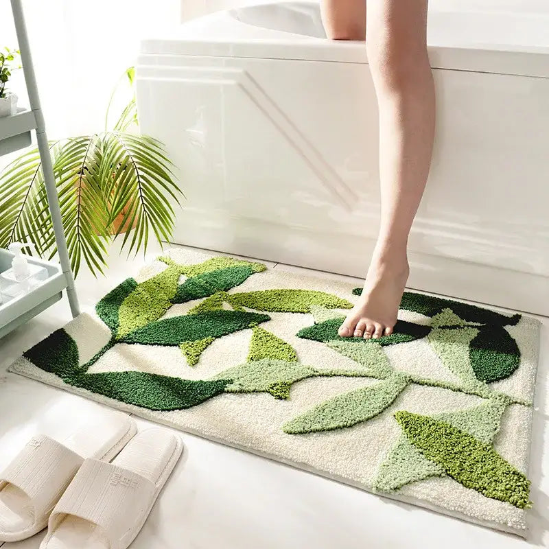 Tapis de bain à feuille verte avec design texturé, matériau doux pour le confort et l’adhérence.