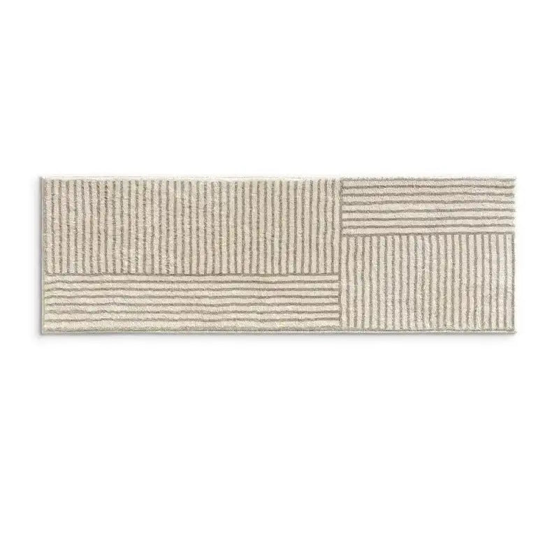 Tapis de bain beige rayé avec un design texturé et un matériau doux.