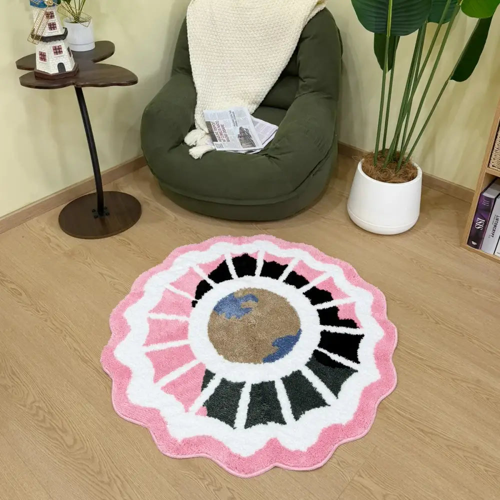 Tapis à motif floral rose, blanc et noir avec un design central de la terre.