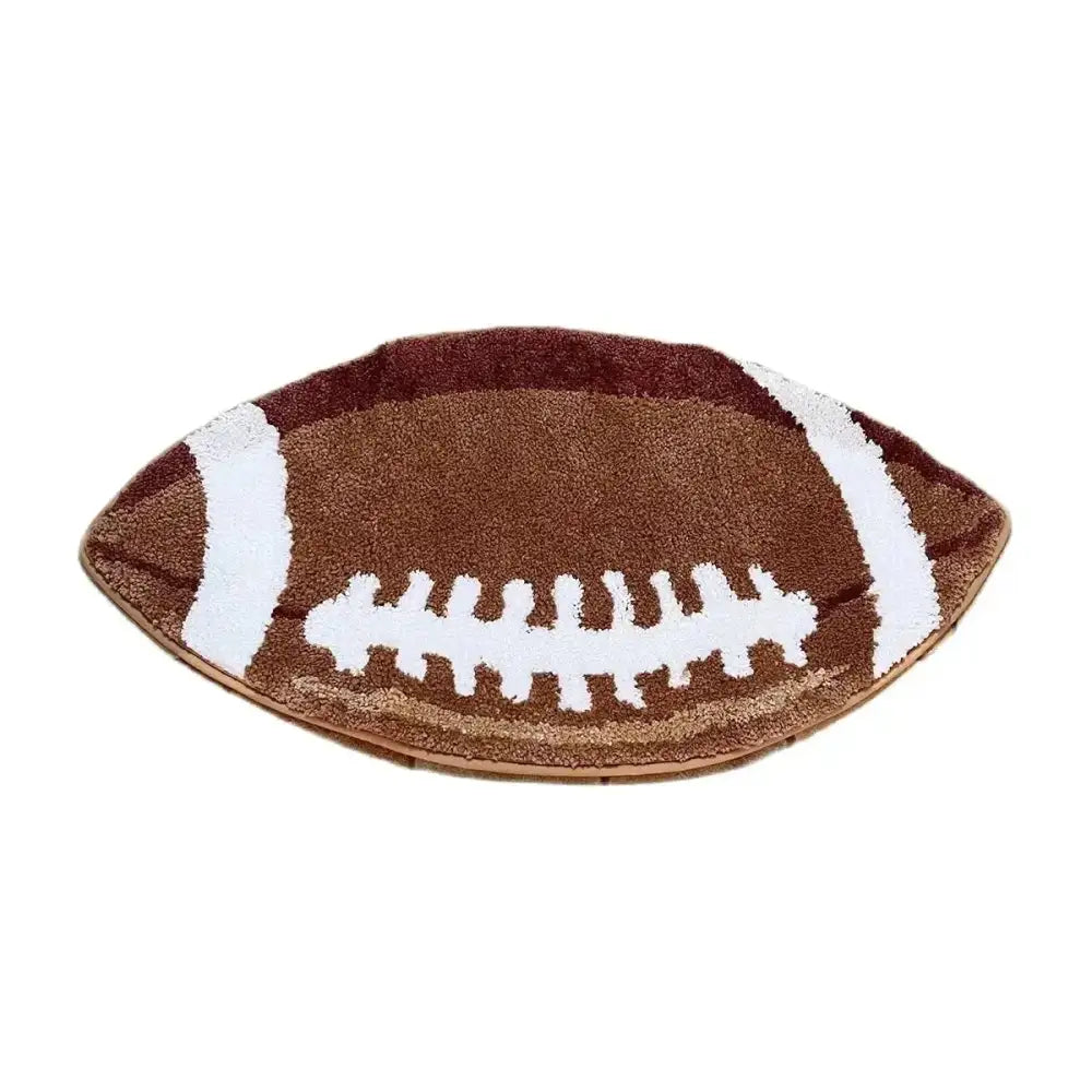Tapis de bain brun en forme de ballon de football avec lacets blancs et détails de coutures.