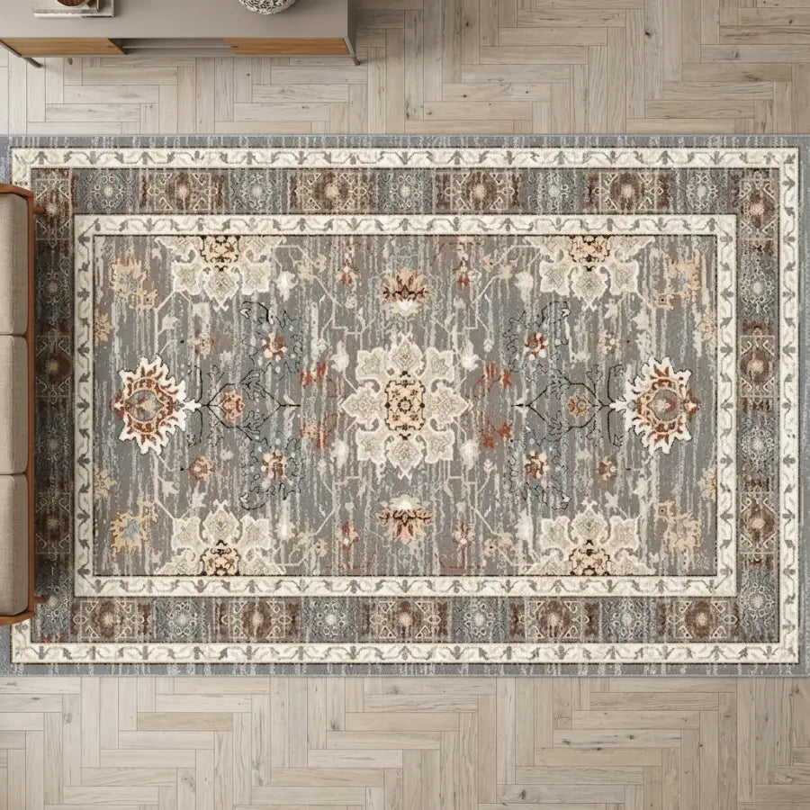 Rectangular tapis gris et terracotta with vintage floral and geometric patterns in muted gris bleuté, beige, and cream tones