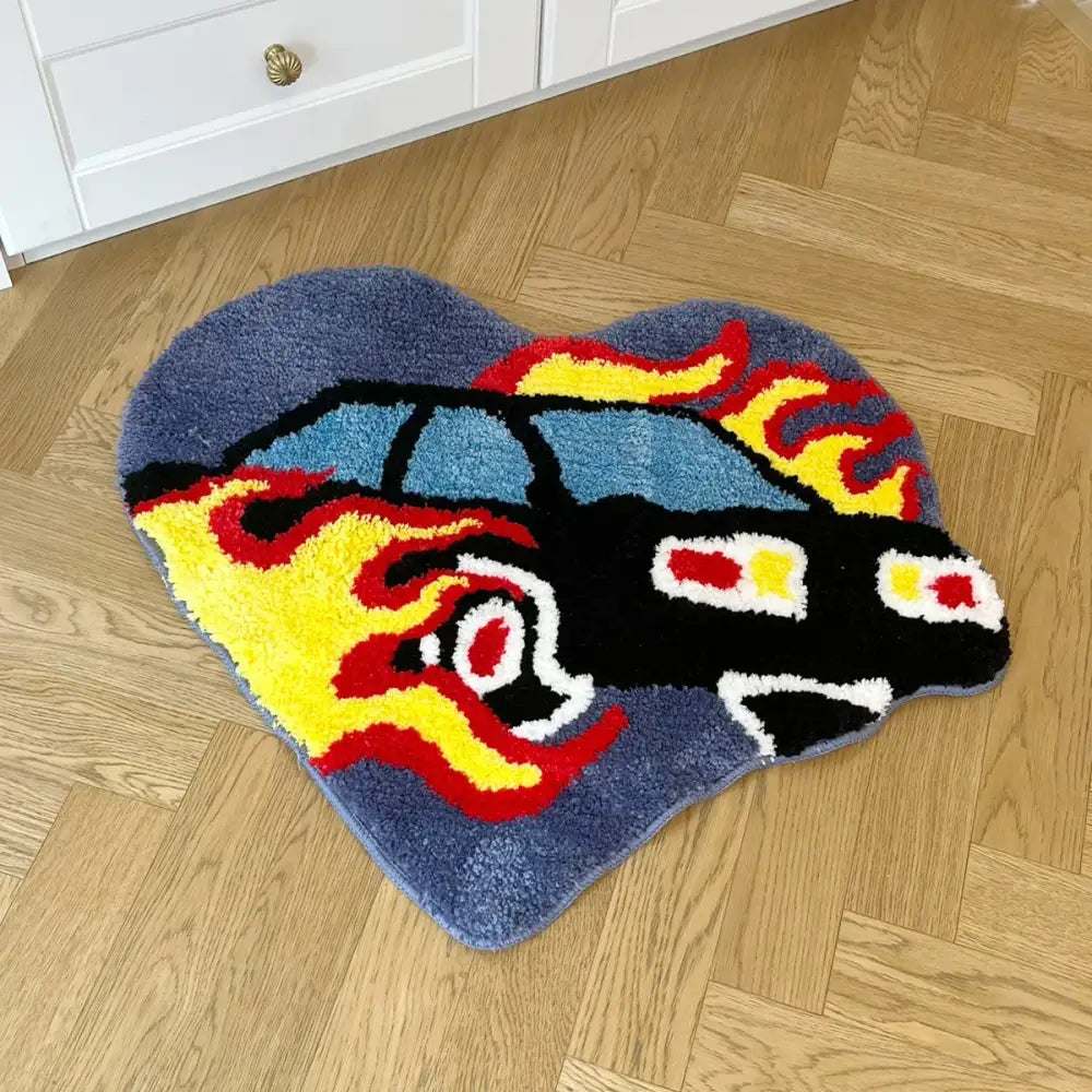 Heart-shaped tapis hot rod rug with a black car and red yellow flames on blue background
