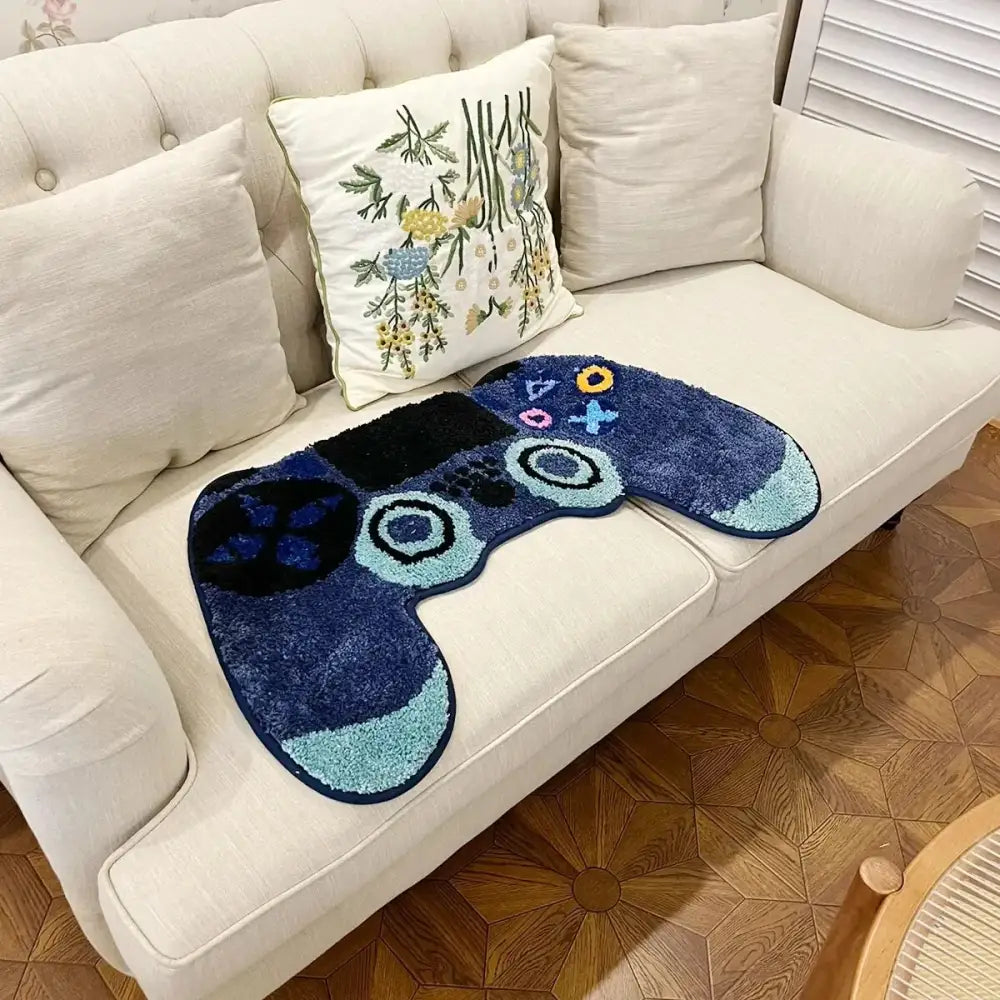 Tapis pour manette de jeu bleu et blanc avec design texturé, probablement fabriqué en matériau moelleux.