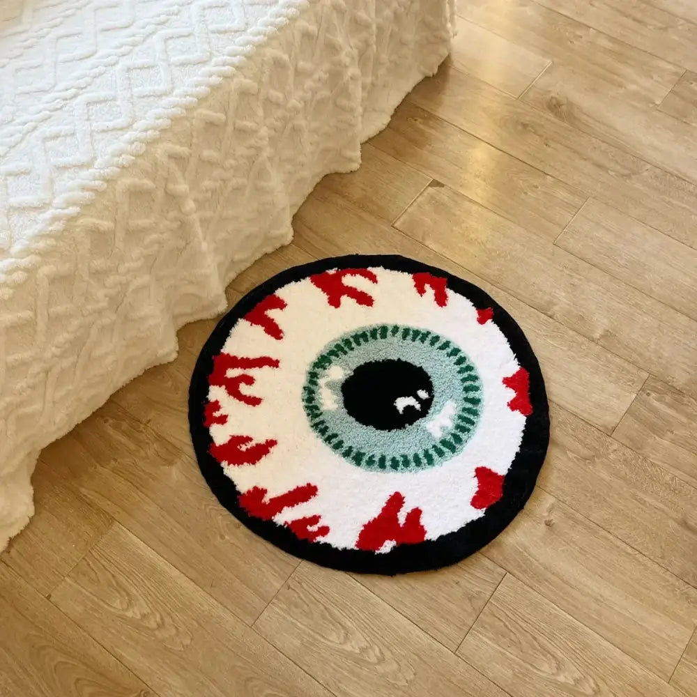 Tapis de bain œil rond avec bordure noire, iris vert et veines rouges, fabriqué en matériau moelleux.