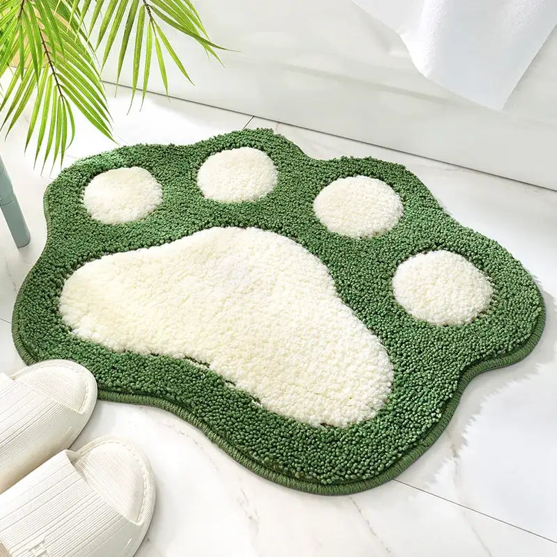 Tapis de bain à empreinte de patte verte avec texture de fourrure blanche et matériau doux.