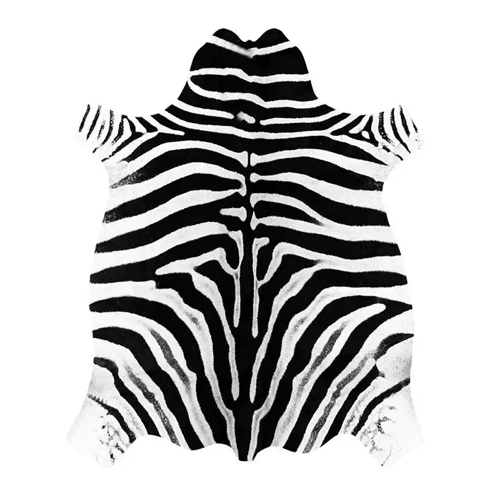 Tapis à motifs zébrés avec des rayures noires et blanches sur une surface texturée, probablement fabriqué en peau de vache.