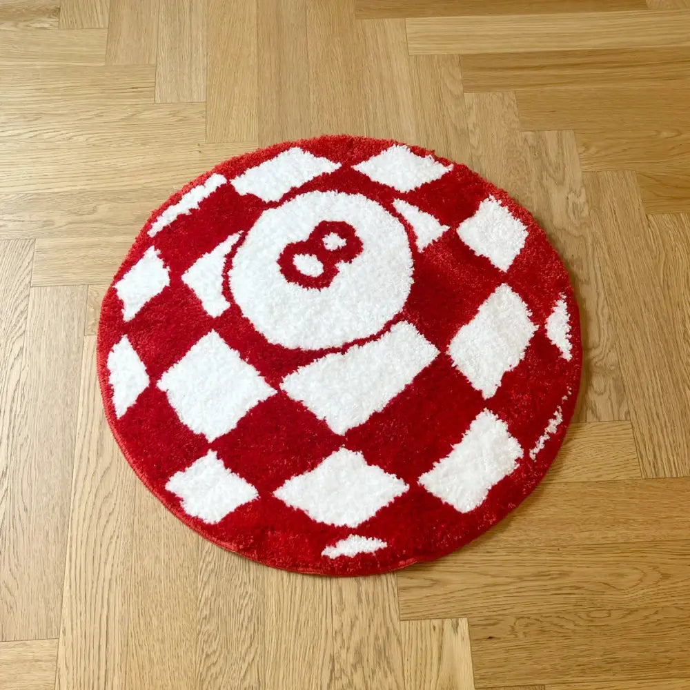 Tapis circulaire en peluche rouge et blanc arborant un design proéminent de boule 8.