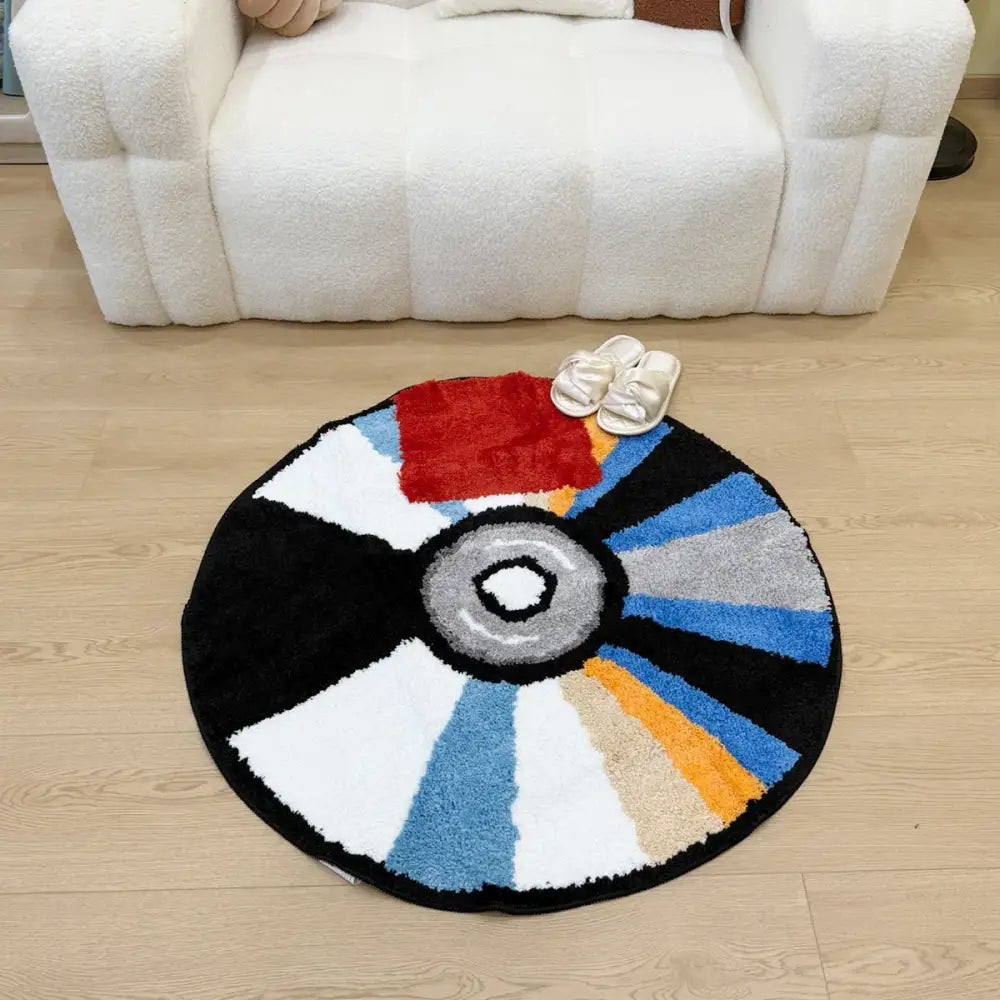Tapis en forme de Pokéball avec un design multicolore et un centre blanc