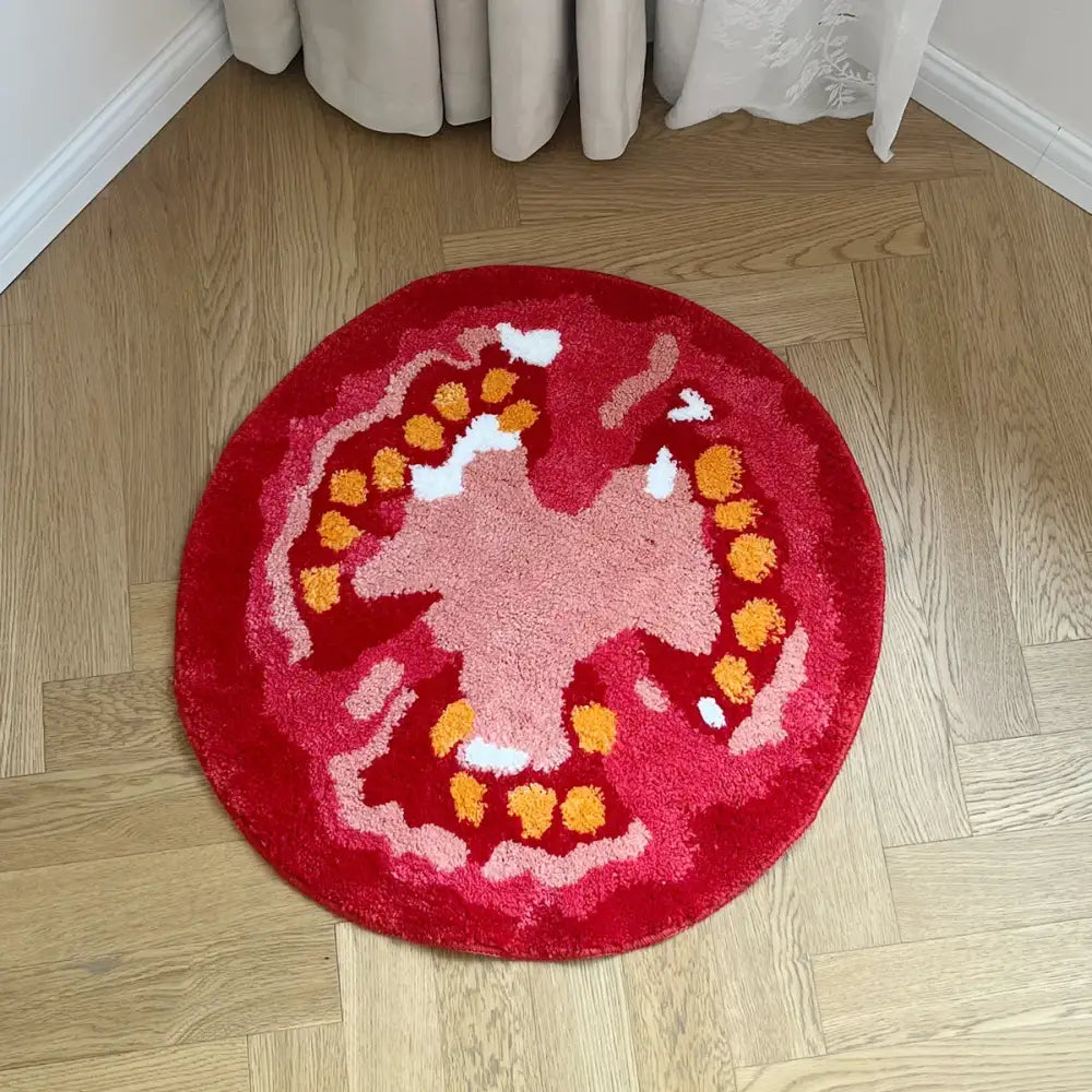 Tapis tomate rond en peluche rouge avec design texturé orange et rose idéal pour coin lecture avec support caoutchouc